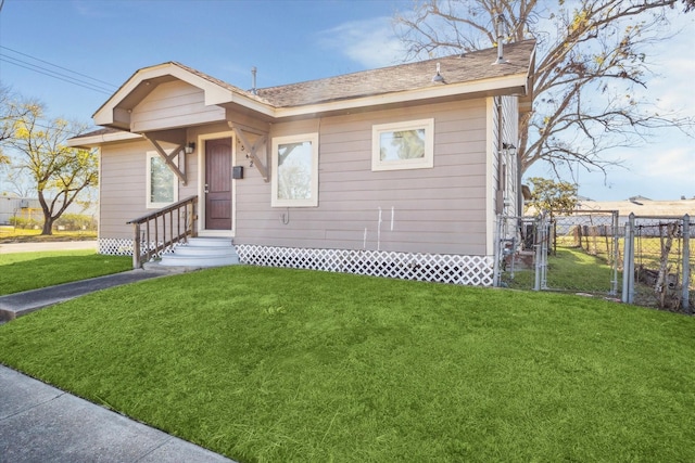 view of front of property with a front lawn and fence