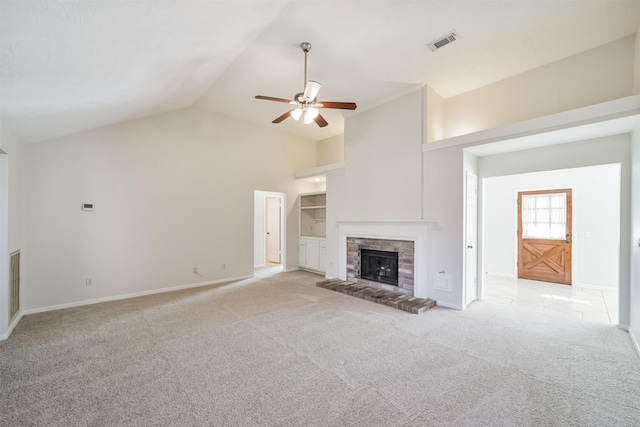 unfurnished living room with visible vents, light colored carpet, a fireplace, and vaulted ceiling