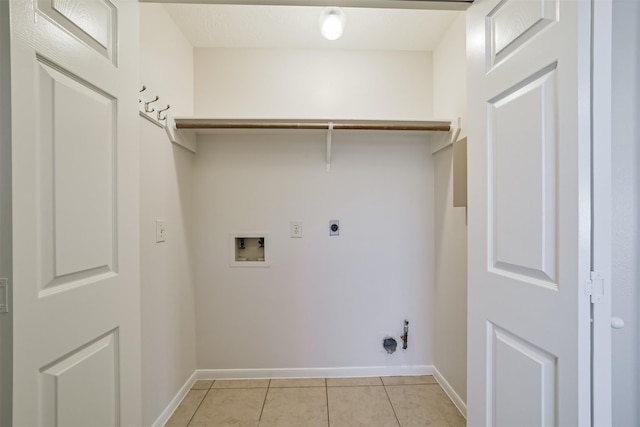 washroom with hookup for a gas dryer, light tile patterned flooring, baseboards, hookup for a washing machine, and laundry area