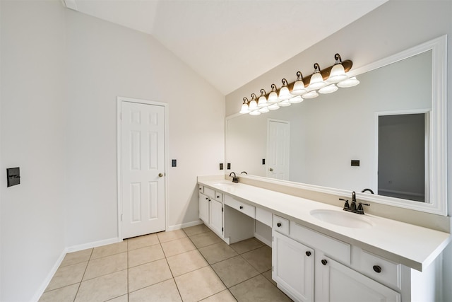 bathroom with tile patterned flooring, lofted ceiling, double vanity, and a sink