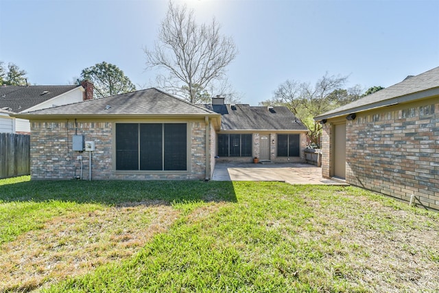 rear view of house featuring a yard, a patio, a chimney, and fence