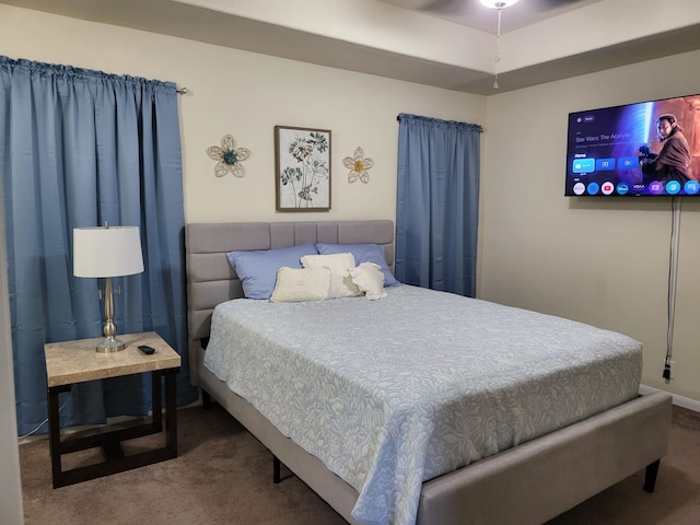 carpeted bedroom featuring baseboards