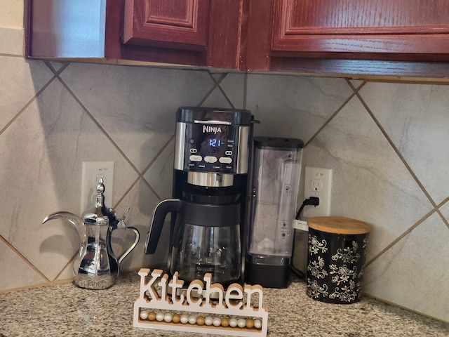 details featuring light stone counters and reddish brown cabinets