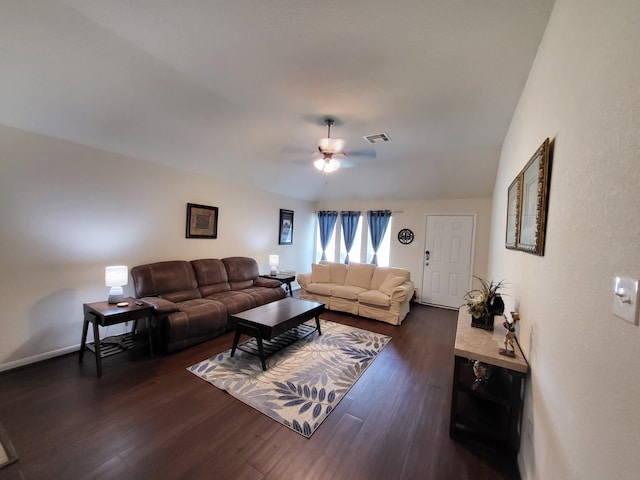 living room with visible vents, baseboards, vaulted ceiling, dark wood-style floors, and a ceiling fan