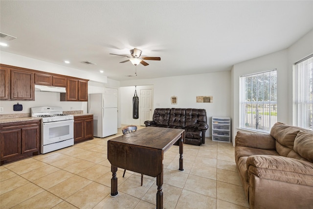 kitchen featuring white appliances, visible vents, open floor plan, and under cabinet range hood