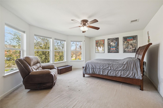 carpeted bedroom featuring visible vents, baseboards, and a ceiling fan