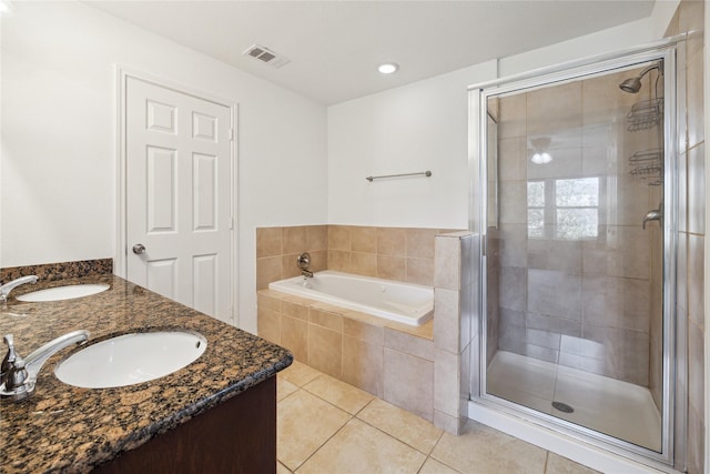 bathroom with tile patterned flooring, visible vents, a stall shower, and a sink