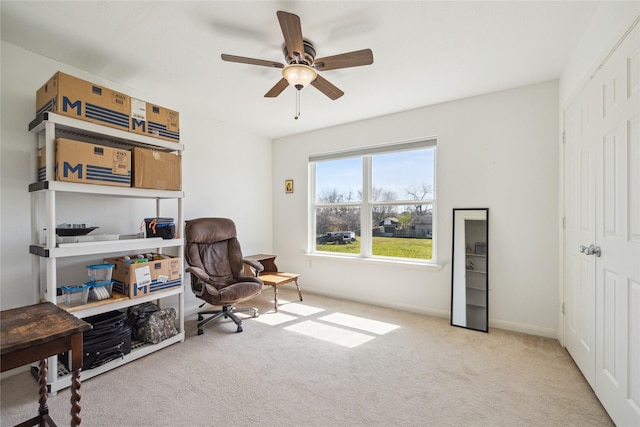 carpeted office with baseboards and ceiling fan