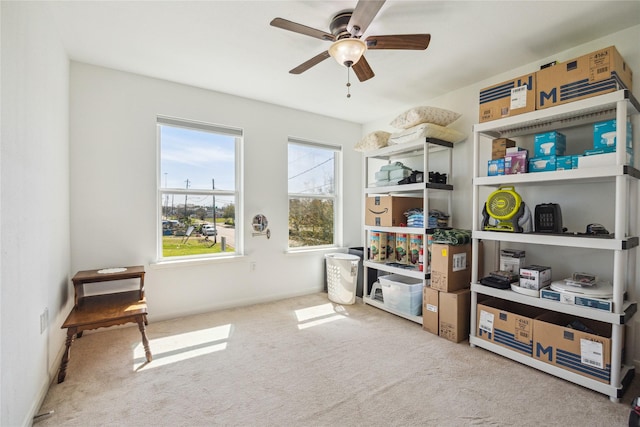 interior space with carpet flooring and ceiling fan