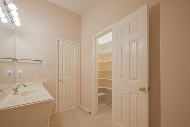 bathroom with baseboards and vanity