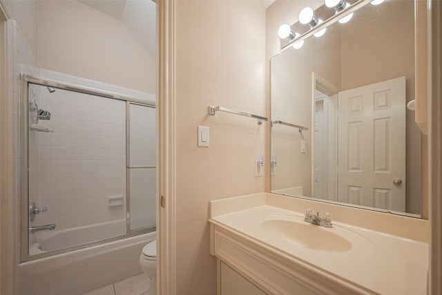 bathroom featuring tile patterned flooring, toilet, vanity, and shower / bath combination with glass door