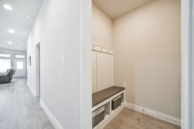 mudroom featuring recessed lighting, light wood-type flooring, and baseboards