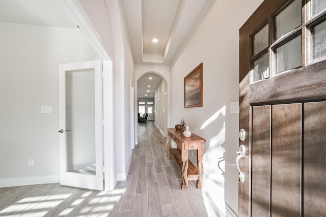 hall with arched walkways, recessed lighting, baseboards, and wood finish floors