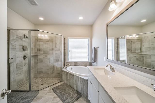 bathroom with a sink, visible vents, a stall shower, and a bath