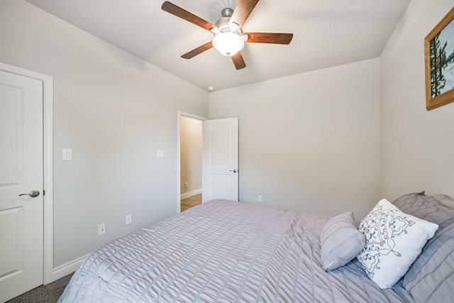 carpeted bedroom with baseboards and ceiling fan