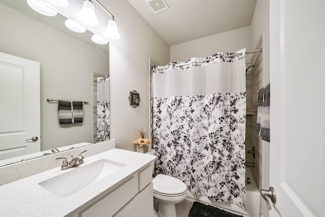 bathroom featuring visible vents, toilet, vanity, and shower / tub combo with curtain