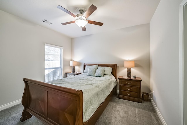 carpeted bedroom featuring a ceiling fan, baseboards, and visible vents