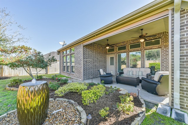 view of patio / terrace with an outdoor living space, a ceiling fan, and fence