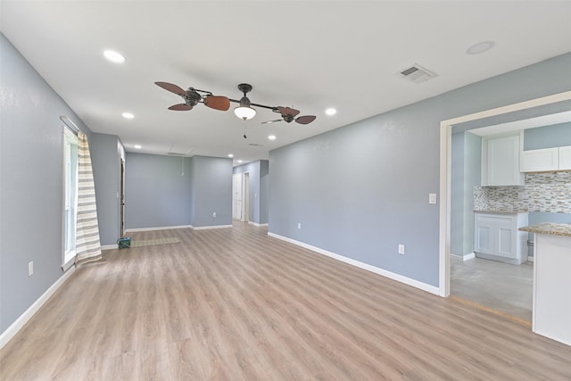 unfurnished living room with visible vents, baseboards, ceiling fan, recessed lighting, and light wood-style floors