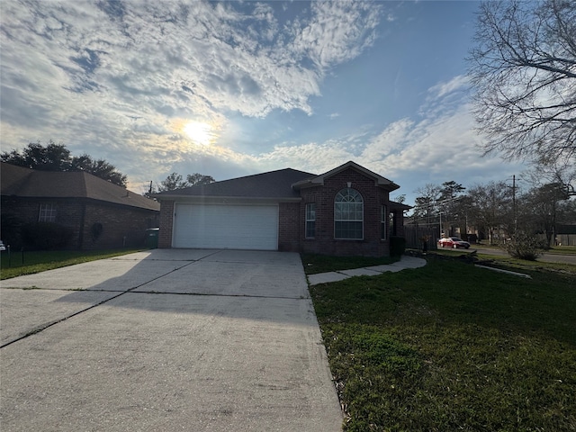 view of front of home with brick siding, an attached garage, concrete driveway, and a front lawn