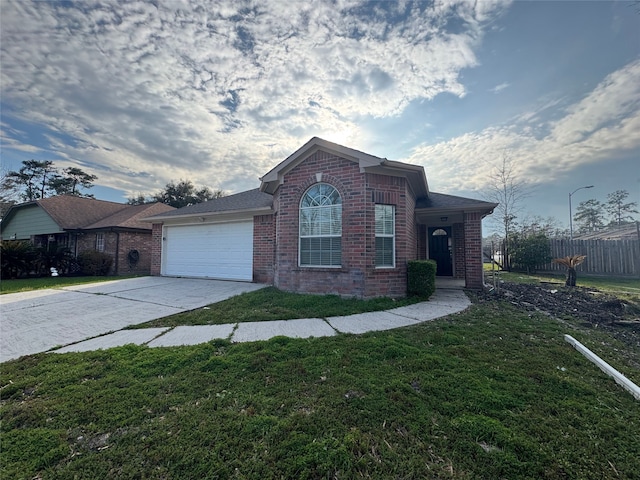 ranch-style house with driveway, a front lawn, fence, an attached garage, and brick siding