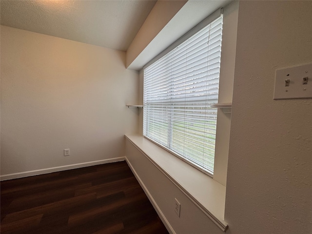 unfurnished room with wood finished floors and baseboards