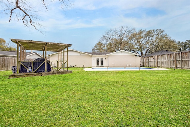 view of yard with french doors, a fenced in pool, a pergola, and a fenced backyard