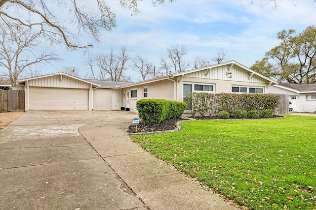 single story home with fence, concrete driveway, a front yard, a garage, and brick siding