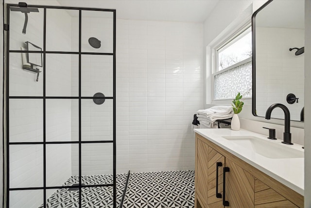 full bathroom with a walk in shower and vanity