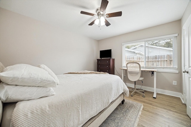 bedroom featuring light wood finished floors, ceiling fan, and baseboards