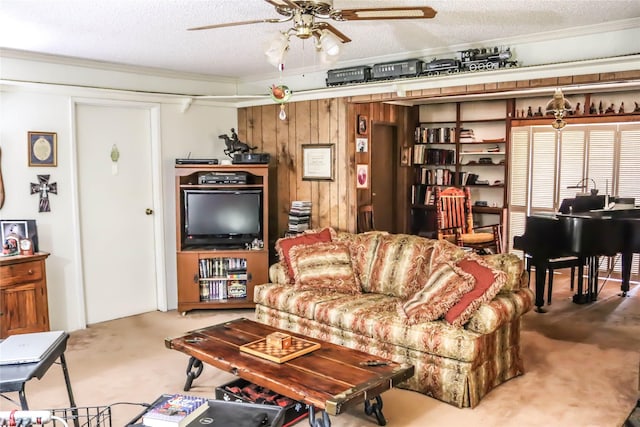 living area with wooden walls, a textured ceiling, a ceiling fan, and carpet