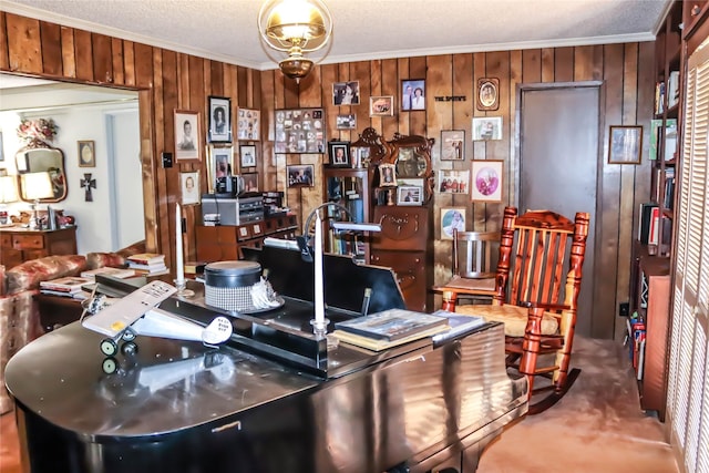 carpeted office featuring a textured ceiling, wooden walls, and ornamental molding