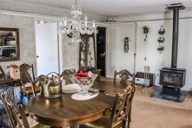carpeted dining room with visible vents, a textured ceiling, a wood stove, and wallpapered walls