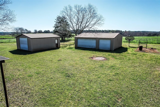 view of yard featuring an outbuilding and a rural view