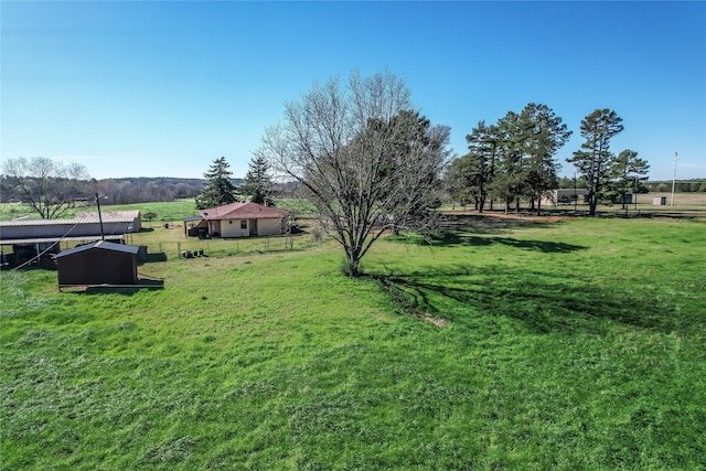 view of yard with a rural view and fence