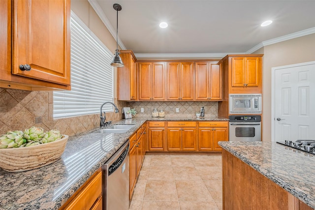 kitchen featuring a sink, stainless steel appliances, stone countertops, and crown molding