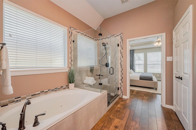 ensuite bathroom featuring visible vents, a shower stall, a garden tub, wood finished floors, and ensuite bath