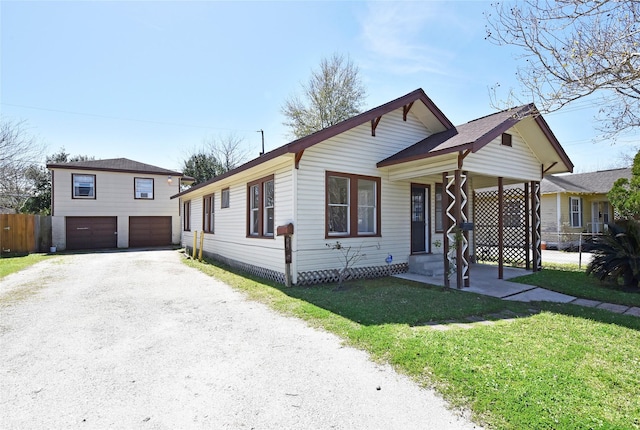 view of front of home with a garage, a front lawn, and fence