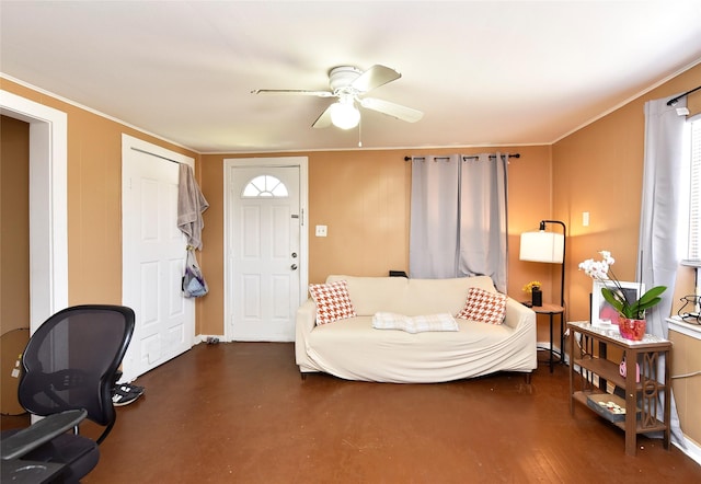 living room with ornamental molding and a ceiling fan