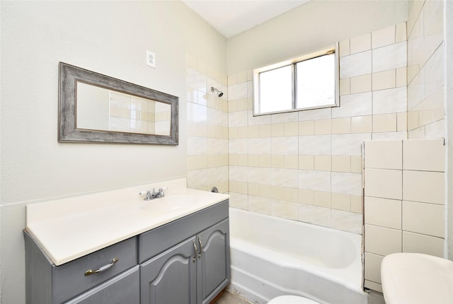 bathroom featuring toilet, vanity, and bathing tub / shower combination