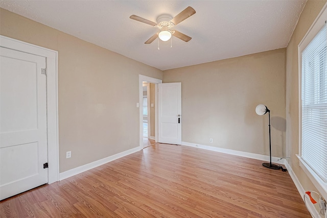 unfurnished room featuring baseboards, ceiling fan, and light wood finished floors