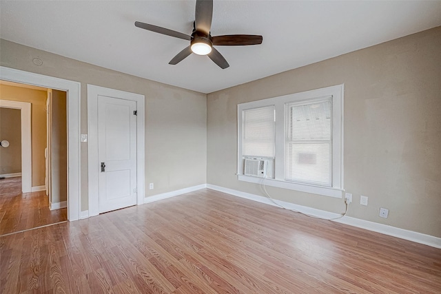 empty room featuring ceiling fan, baseboards, and light wood-style flooring