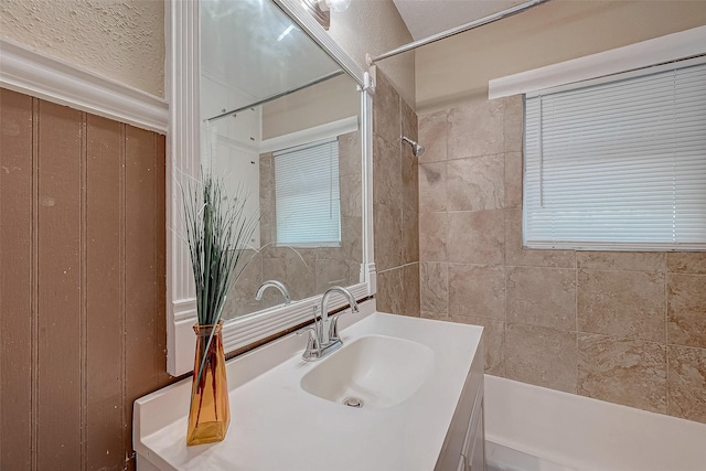 bathroom with vanity and a shower