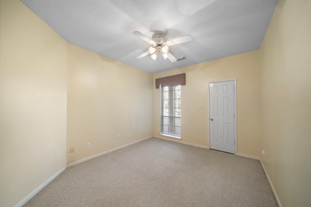 unfurnished room with visible vents, baseboards, ceiling fan, and carpet floors