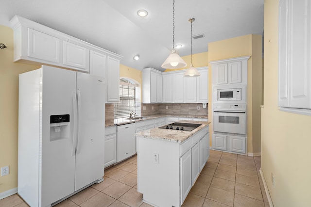 kitchen with white appliances, visible vents, white cabinets, tasteful backsplash, and a center island