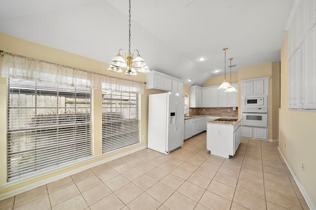 kitchen with light tile patterned floors, backsplash, white appliances, and lofted ceiling