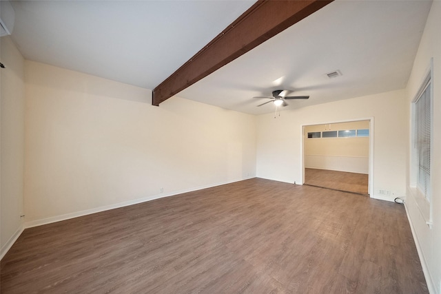 spare room with visible vents, baseboards, beamed ceiling, wood finished floors, and a ceiling fan