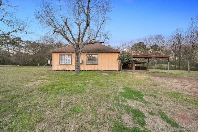 view of side of property featuring a lawn and roof with shingles