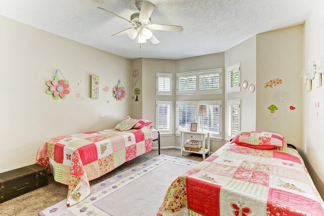 bedroom with baseboards, carpet, a ceiling fan, and a textured ceiling