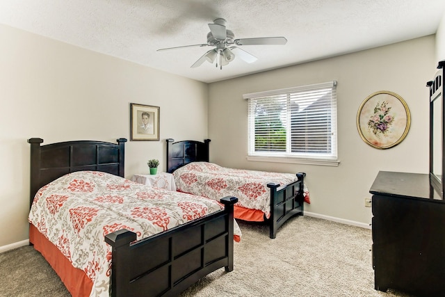 bedroom with light colored carpet, a textured ceiling, baseboards, and a ceiling fan